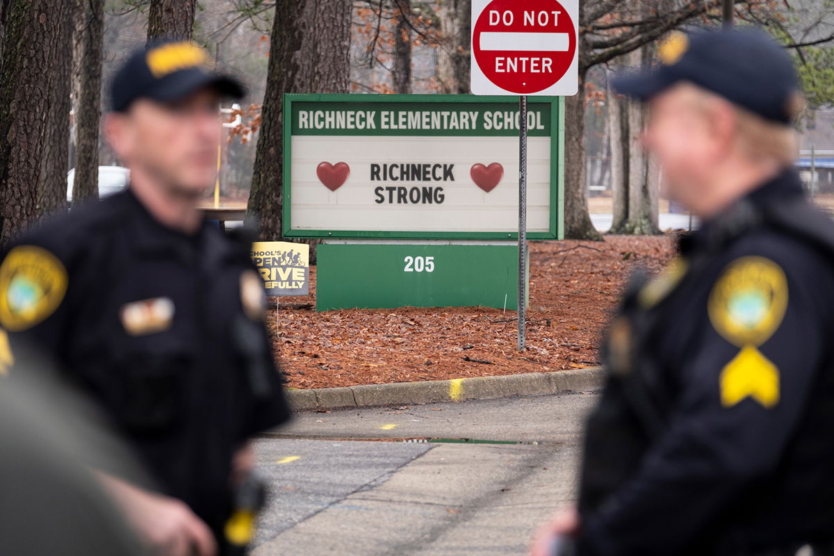 <i>Billy Schuerman/AP</i><br/>Police look on as students return to Richneck Elementary in Newport News