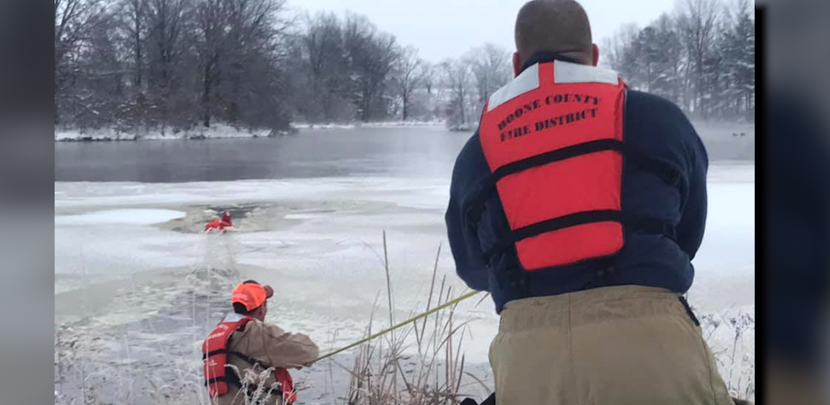 Firefighters work to pull a dog from a frozen pond off of Highway HH. Photo provided by the Boone County Fire Protection District