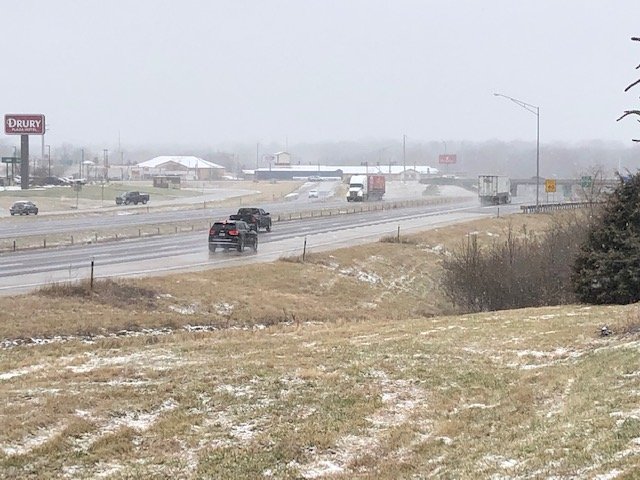 Vehicles travel along Interstate 70 in Columbia as snow falls Saturday, Jan. 11, 2020.