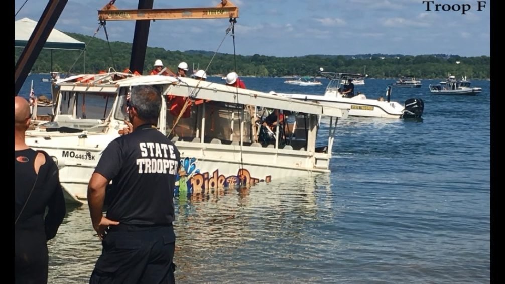 Missouri State Highway Patrol troopers observe as a duck boat is removed from Table Rock Lake after its sinking.