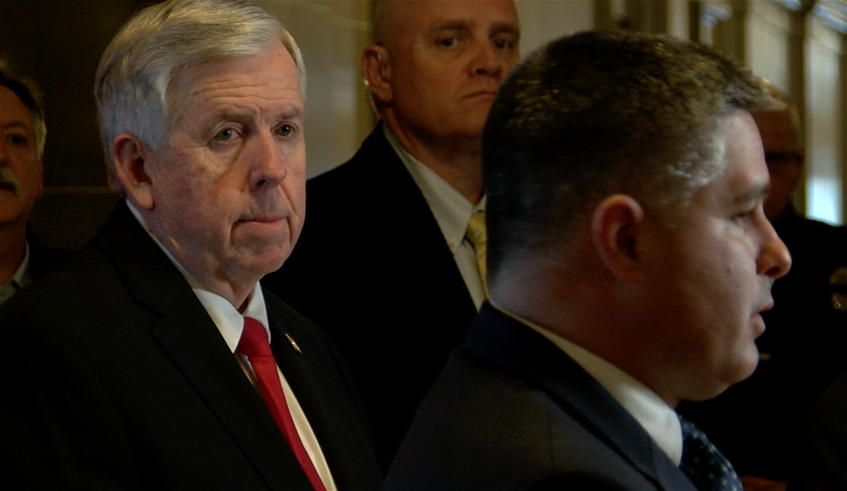 Gov. Mike Parson, left, attends a daily briefing regarding Missouri's response to COVID-19.