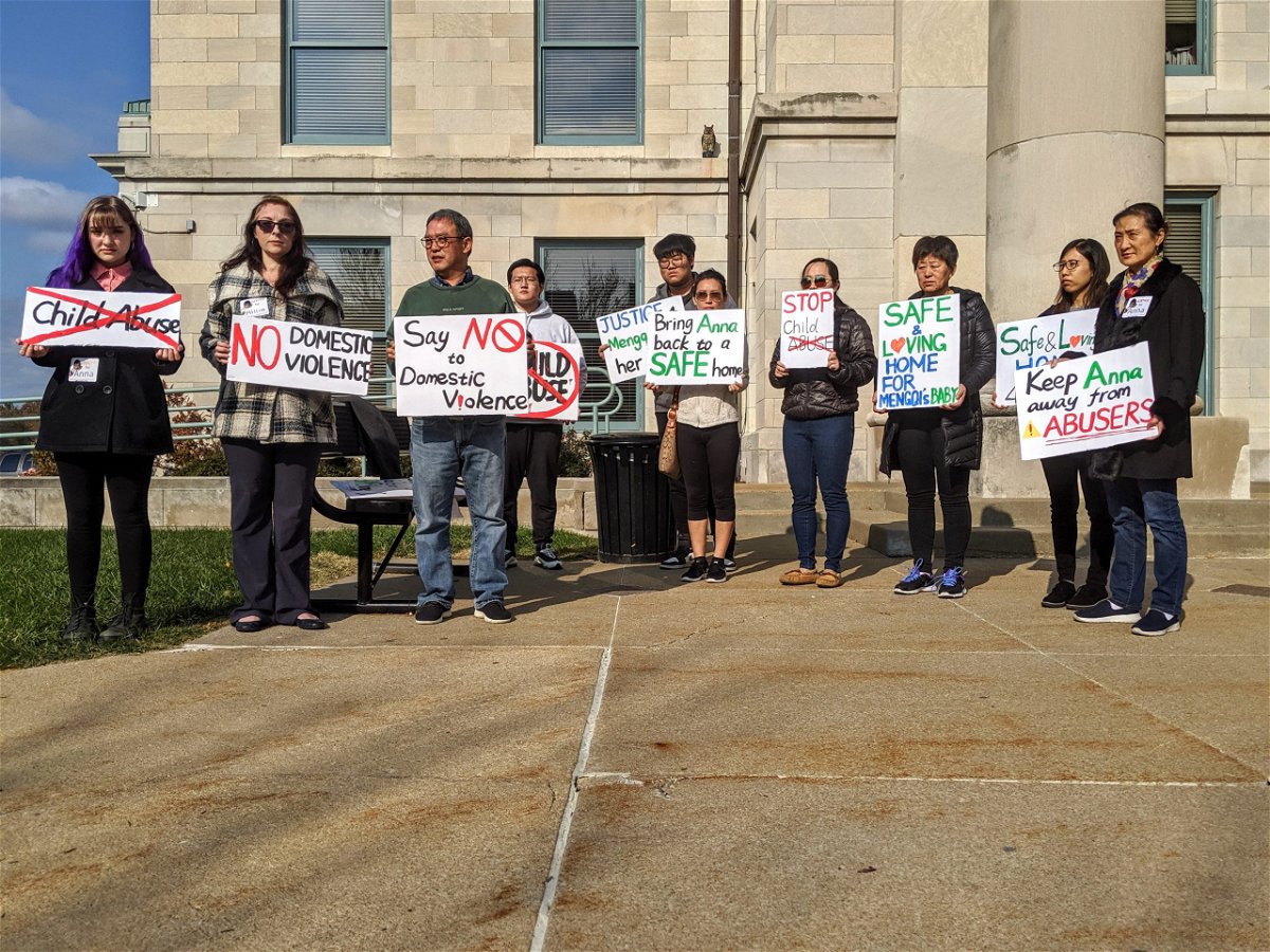 Supporters of Mengqi Elledge's family hold signs outside the Boone County Courthouse on Wednesday, Nov. 6, 2019, while Mengqi's husband, Joseph Elledge, has a criminal court appearance inside. 