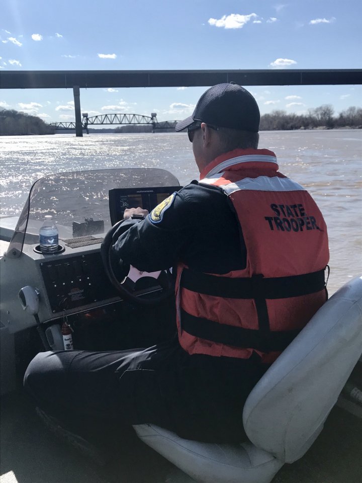 A Missouri State Highway Patrol trooper searches the Missouri River at Boonville on Sunday, March 30, 2020. Authorities were looking for a man who was seen jumping off the bridge.
