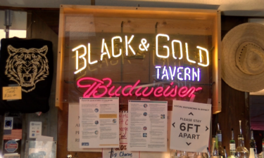 Black & Gold Tavern posted signs reminding customers to social distance.
