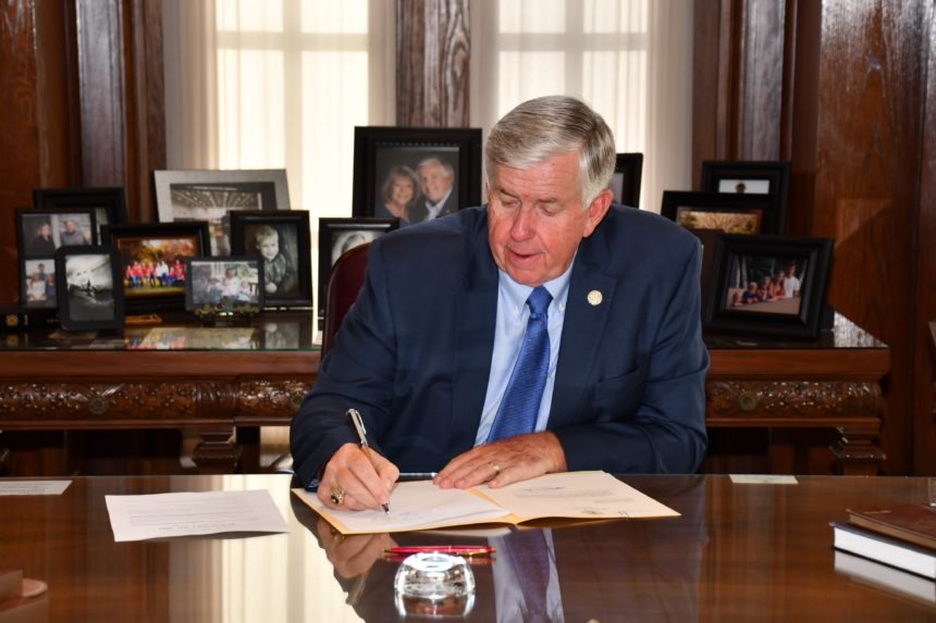 Gov. Mike Parson signs the fiscal 2021 budget