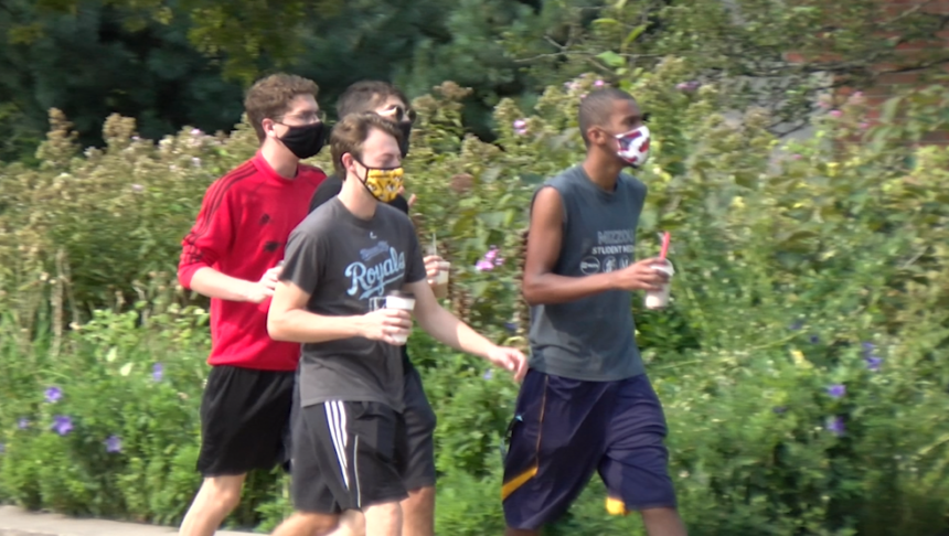 Students walk across the MU campus with masks on