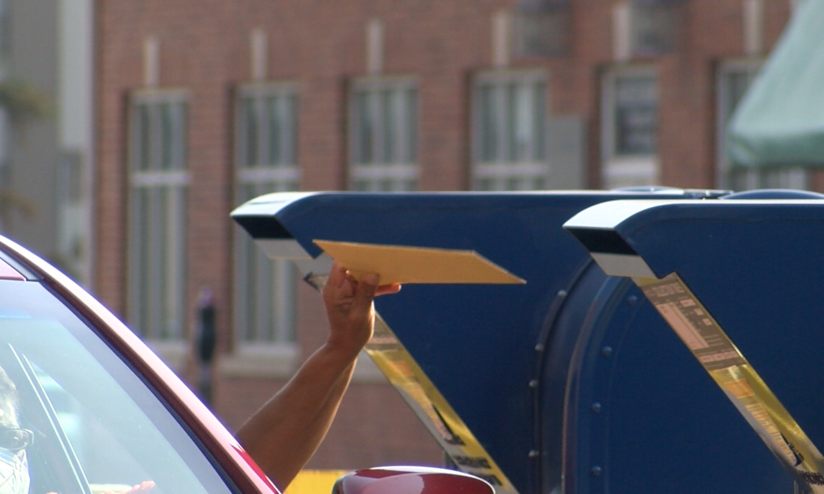 A driver drops off mail at the Columbia post office