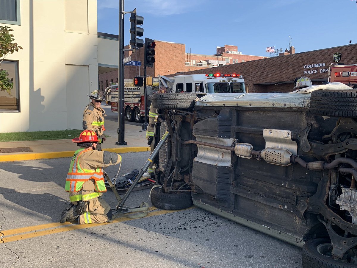 Columbia firefighters work to pull someone from a vehicle in downtown Columbia