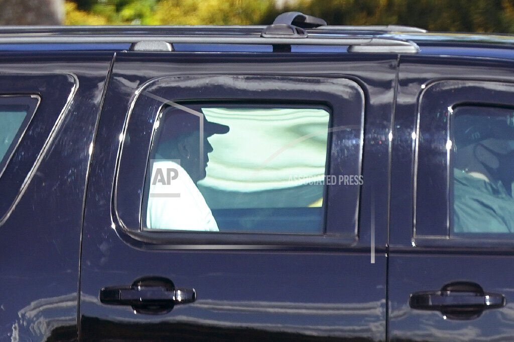 President Donald Trump rides in a motorcade vehicle as he departs Trump International Golf Club, Sunday, Dec. 27, 2020, in West Palm Beach, Fla. (AP Photo/Patrick Semansky)