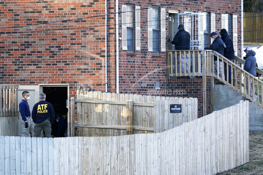 FBI and ATF agents investigate a home Saturday, Dec. 26, 2020, in Nashville, Tenn. An explosion that shook the largely deserted streets of downtown Nashville early Christmas morning shattered windows, damaged buildings, and wounded three people. Authorities said they believed the blast was intentional. (AP Photo/Mark Humphrey)