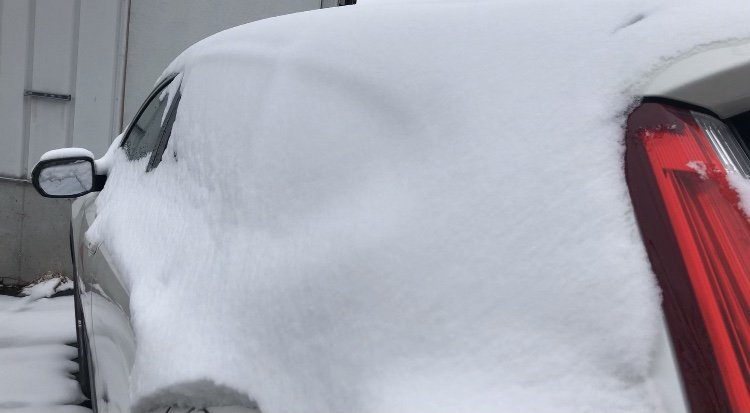 Car in Columbia covered in snow