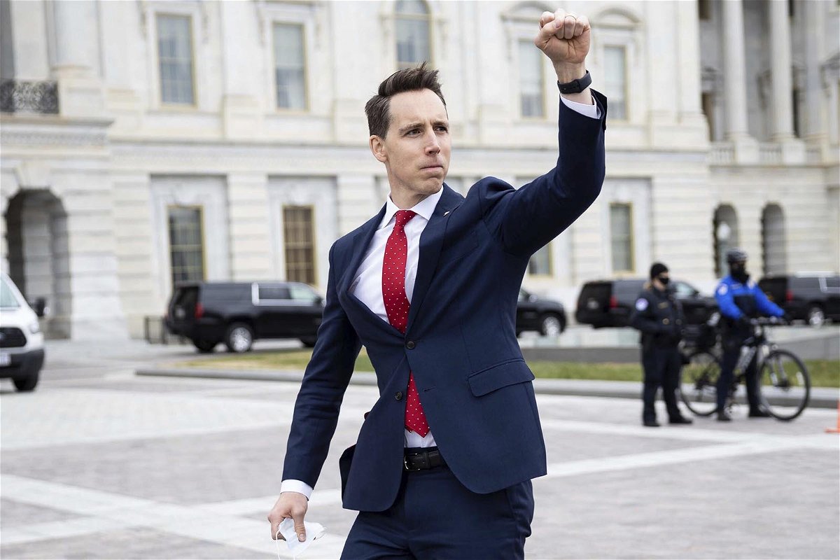 Sen. Josh Hawley (R-Mo.) gestures toward a crowd of supporters of President Donald Trump gathered outside the U.S. Capitol to protest the certification of President-elect Joe Biden's electoral college victory Jan. 6, 2021 at the US Capitol in Washington, DC. Some demonstrators later breached security and stormed the Capitol. (Francis Chung/E&E News and Politico via AP Images)