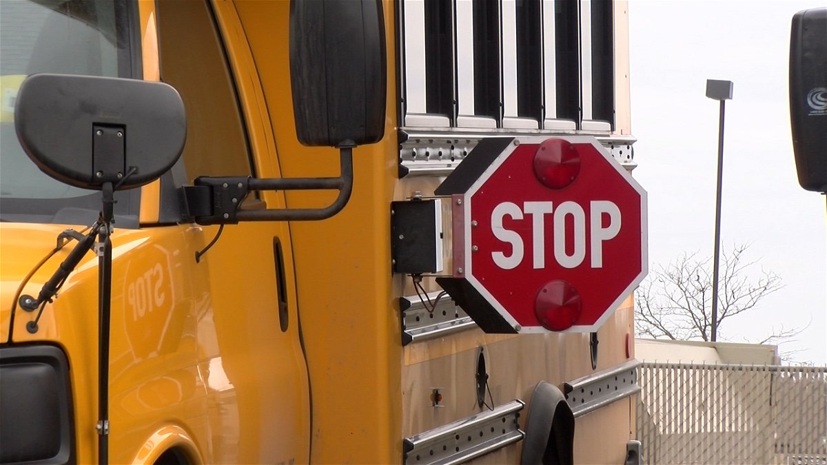 A bus sits with its stop sign out at the Student Transportation of America bus garage in Columbia.