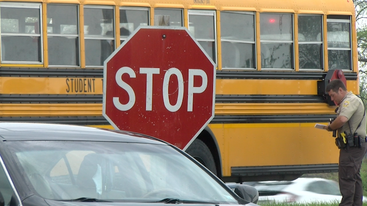 A CPS school bus near a stop sign.