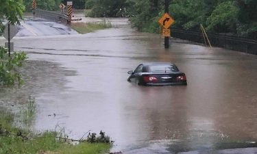 Car in floodwaters on Cave Creek Road