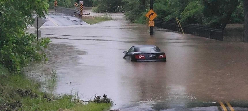 Car in floodwaters on Cave Creek Road