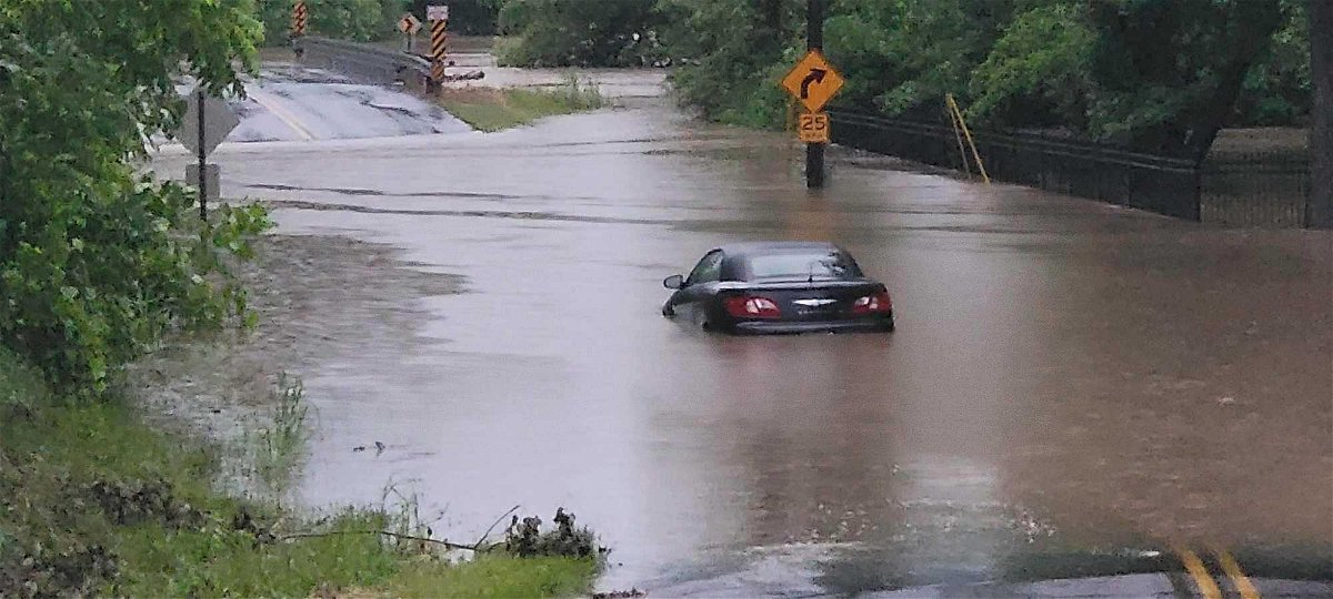 A car is stuck in floodwaters Friday, June 25, 2021, on Cave Creek Road in Boone County.