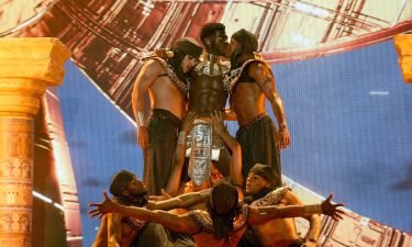 Lil Nas X (center) performs kisses one of his male backup dancers during a performance on Sunday at the BET Awards 2021.