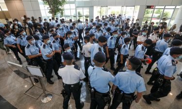 Police officers raid the Apple Daily office on June 17 in Hong Kong.