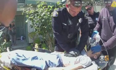 Body cam footage of Officer Christopher Reed performing chest compressions on a woman who suffered a heart attack following a house fire on June 29