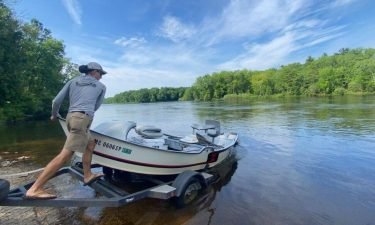 Gabe Stelzer launches his drift boat last week on the Michigan side of the Menominee River just below the Upper Peninsula's Grand Rapids power dam.