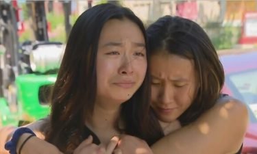 Victoria Gin (right) holds Joyce Lui (left) as she cries while talking about the death of her friend