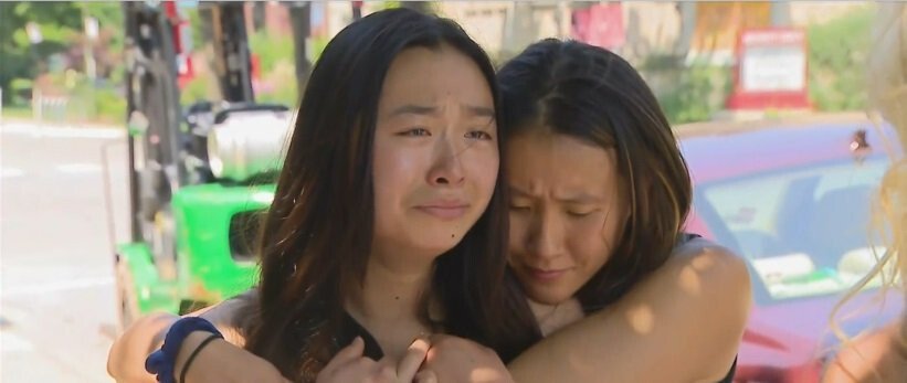 <i>WBBM</i><br/>Victoria Gin (right) holds Joyce Lui (left) as she cries while talking about the death of her friend
