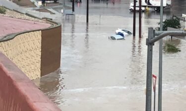 El Paso roads overwhelmed with flood water and cars submerged.