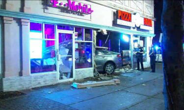 Police say a stolen SUV driven by a 24-year-old woman smashed through the front of a Belleville pizzeria and adjacent cell phone store