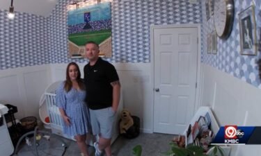 Josh and Amber Taylor stand in a nursery that was supposed to be his man cave.