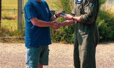 Photographer Ian Simpson meets fighter pilot Maj. Grant Thompson on July 20 after Simpson made a potentially lifesaving intervention when he spotted something wrong with Thompson's F-15E Strike Eagle fighter jet.