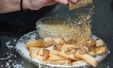 Chef Frederick Schoen-Kiewert applies 23-carat edible gold dust on top. as he prepares The Creme de la Creme Pommes Frites