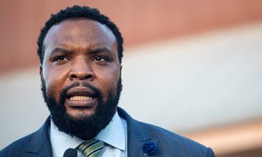 Attorney Lee Merritt speaks during a candle light vigil in honor of Jonathan Price on October 5