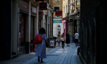 Pedestrians walk on Bow Street in the City of London on July 19. The UK government's decision to lift almost all remaining coronavirus restrictions in England was expected to deliver a windfall for businesses that have been hampered by social distancing rules.