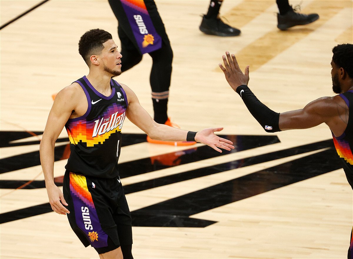 <i>Christian Petersen/Getty Images</i><br/>Devin Booker #1 of the Phoenix Suns is congratulated by teammates while coming to the bench for a time out during the second half in Game Two of the NBA Finals against the Milwaukee Bucks at Phoenix Suns Arena on July 8 in Phoenix