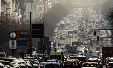 The morning rush hour on the street Bismarckstrasse is pictured during morning light on February 25 in Berlin