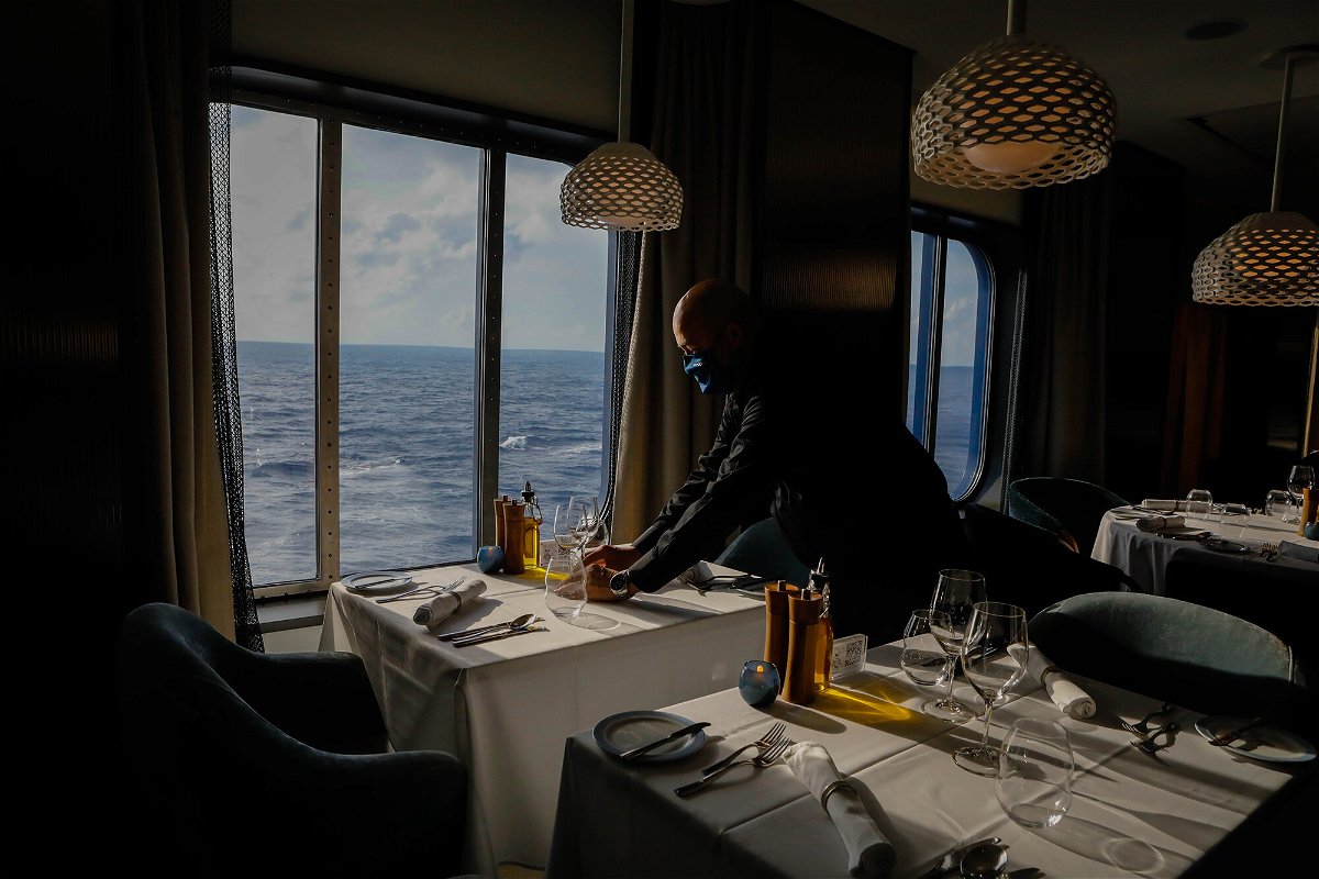 <i>Eva Marie Uzcategui/Bloomberg/Getty Images</i><br/>An employee sets a table at Cyprus Restaurant on the Celebrity Edge cruise ship on June 27.