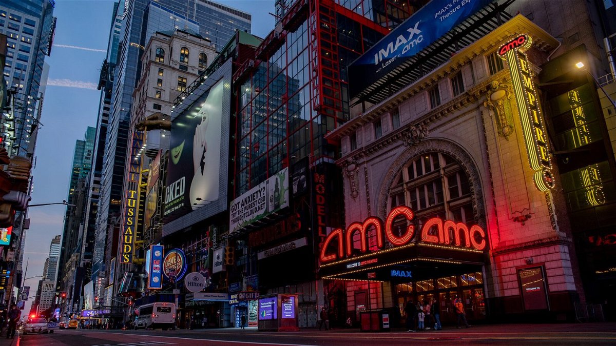 <i>Amir Hamja/Bloomberg/Getty Images</i><br/>Signage is displayed outside an AMC movie theater at night in the Times Square neighborhood of New York on Oct. 15
