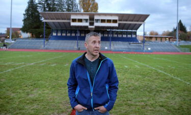 Former Bremerton High School assistant football coach Joe Kennedy stands at the center of the field on the 50 yard line at Bremerton Memorial Stadium