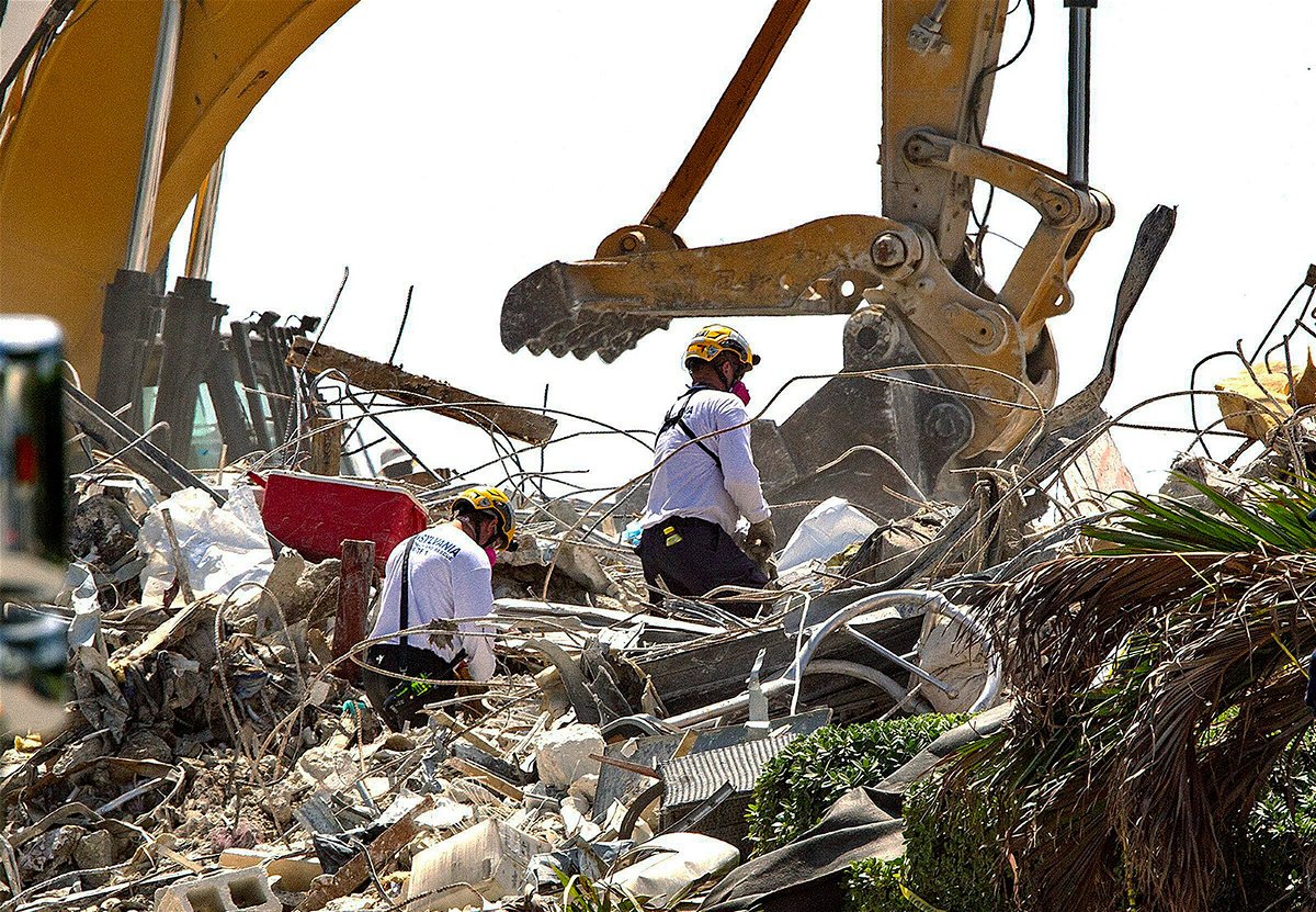 <i>Pedro Portal/AP</i><br/>Rescue teams from Pennsylvania search the rubble of the Champlain Towers South on July 8.