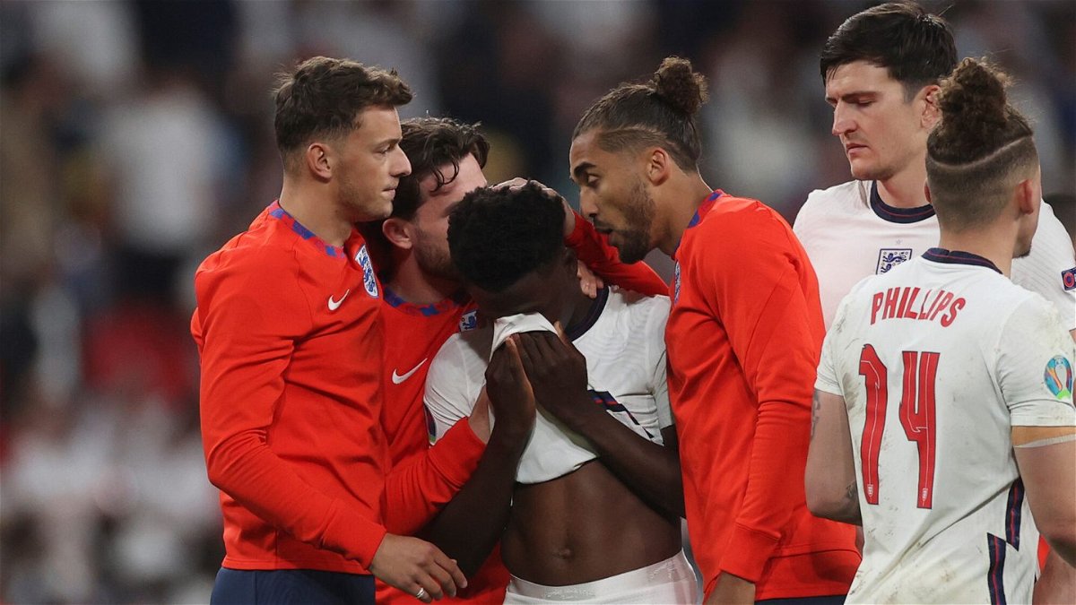 <i>Carl Recine/AP</i><br/>England players comfort teammate Bukayo Saka after he missed a penalty during a penalty shootout after extra time against Italy.