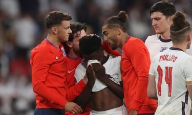England players comfort teammate Bukayo Saka after he missed a penalty during a penalty shootout after extra time against Italy.