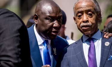 Attorney Ben Crump (left) and the Rev. Al Sharpton join the family of George Floyd outside the Hennepin County Government Center after the sentencing of Derek Chauvin on June 25 in Minneapolis.