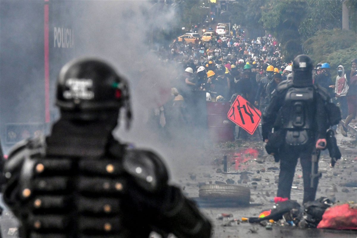 <i>Joaquin Sarmiento/AFP/Getty Images</i><br/>Riot police clash with protesters in Medellin