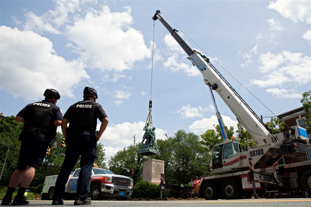 <i>RYAN M. KELLY/AFP/Getty Images</i><br/>Police look on as the statue of Meriwether Lewis