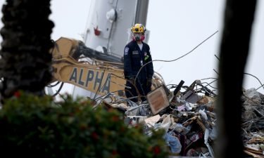 A rescue worker works on top of the collapsed 12-story Champlain Towers South condo building on July 10 in Surfside