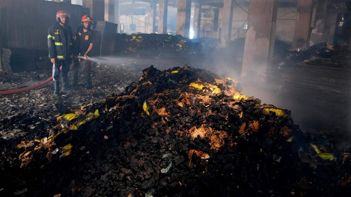 <i>Mahmud Hossain Opu/AP</i><br/>Firefighters work to douse the fire at the factory on July 9.