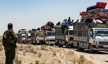 Families sit in trucks after their release from a camp holding relatives of suspected Islamic State fighters in northeastern Syria.