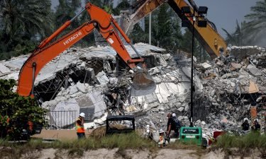 Excavators dig through the remains from the collapsed 12-story Champlain Towers South condo building on July 9 in Surfside