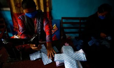 A volunteer stitches cloth to make reusable sanitary pads at Sinamangal in Kathmandu